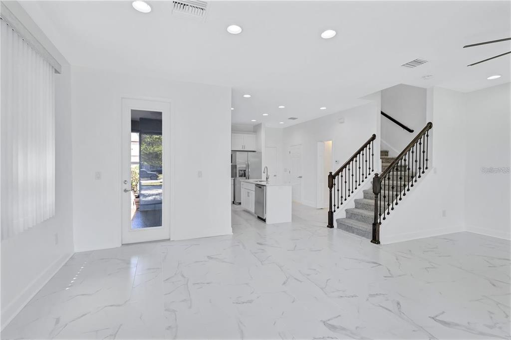 5830 Circa Fishhawk Boulevard Lithia, FL 33547 - Photo 8 of 37 an empty room with white walls and stairs