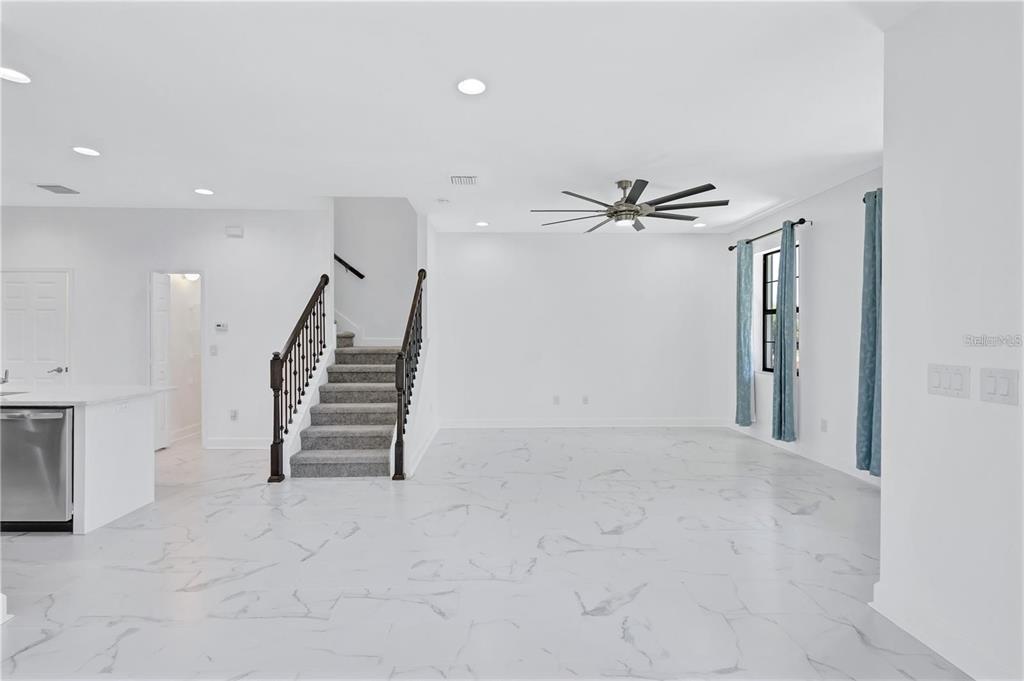 5830 Circa Fishhawk Boulevard Lithia, FL 33547 - Photo 9 of 37 wooden floor in an empty room with a ceiling fan