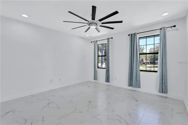 a view of a livingroom with a ceiling fan and window