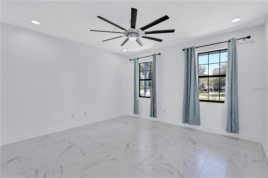 5830 Circa Fishhawk Boulevard Lithia, FL 33547 - Photo 10 of 37 a view of a livingroom with a ceiling fan and window