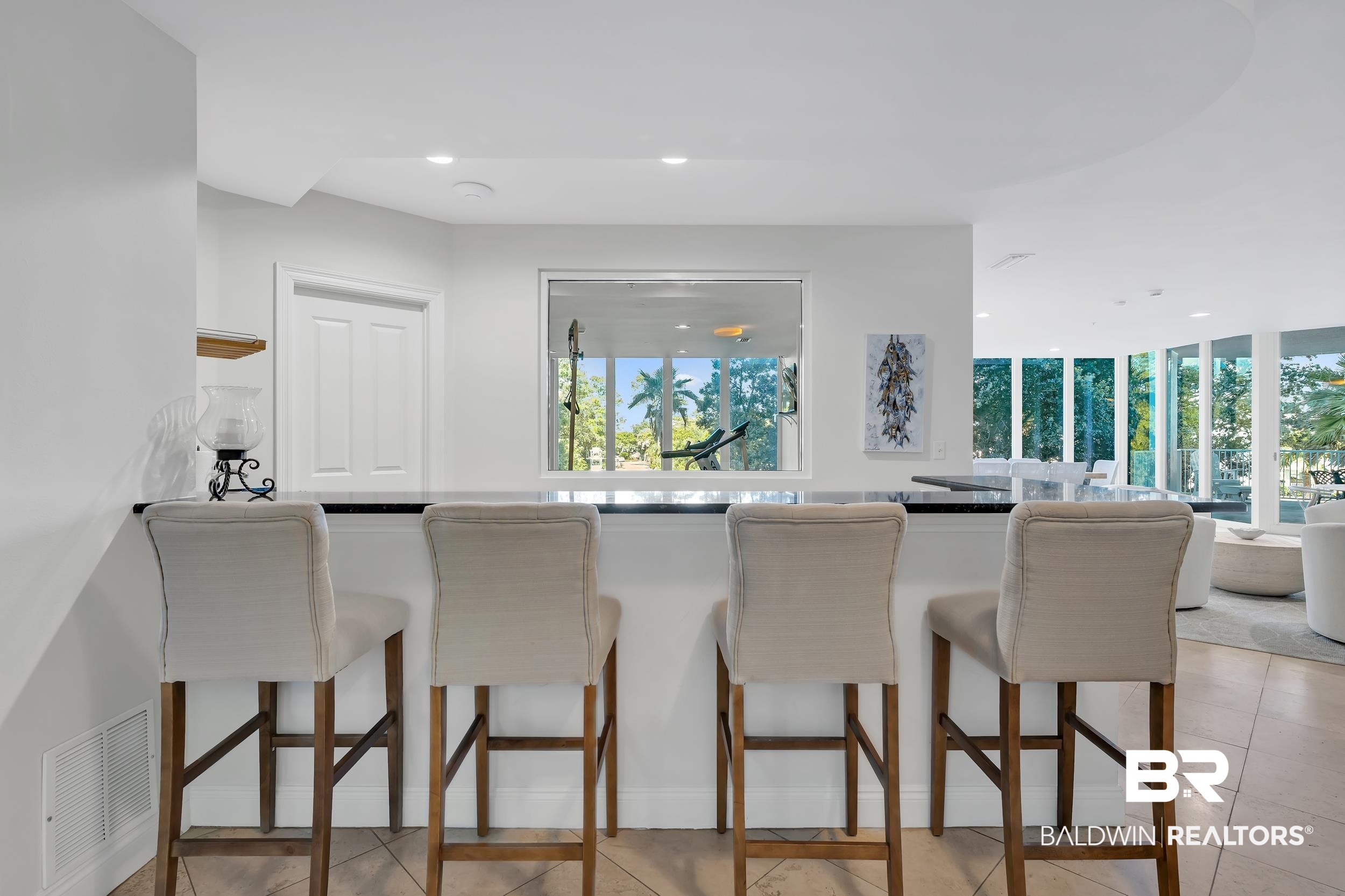28250 Canal Road, Unit 307 Orange Beach, AL 36561 - Photo 56 of 56 Kitchen with recessed lighting, dark countertops, a breakfast bar area, light tile patterned floors, and open floor plan