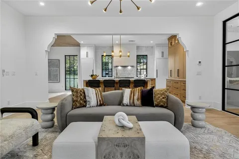 a bedroom with a large bed and a chandelier