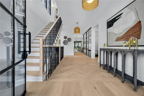 a dining room with furniture and wooden floor