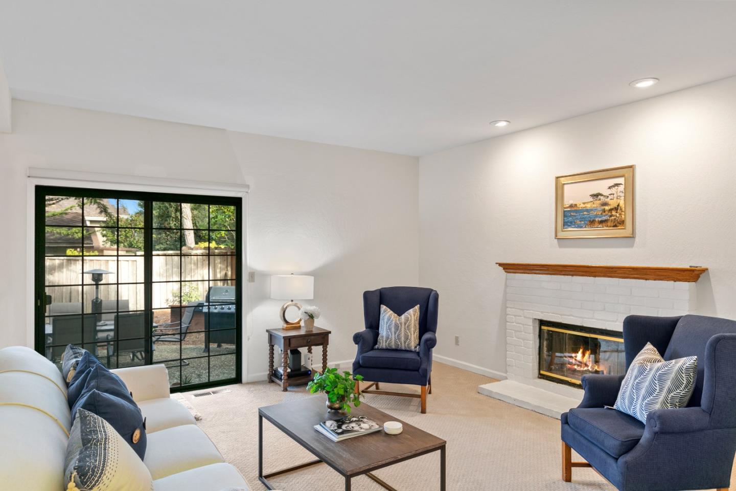 3017 Lopez Road Pebble Beach, CA 93953 - Photo 11 of 30 a living room with furniture a fireplace and a floor to ceiling window