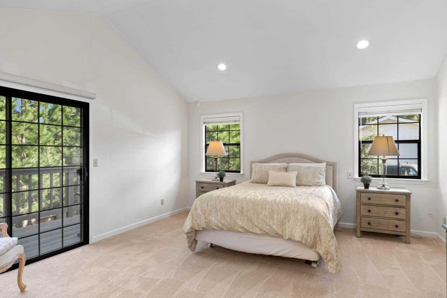 3017 Lopez Road Pebble Beach, CA 93953 - Photo 16 of 30 a bedroom with a bed a table and a window