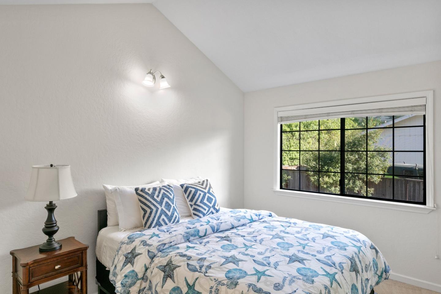 3017 Lopez Road Pebble Beach, CA 93953 - Photo 19 of 30 a bedroom with a large bed and a window