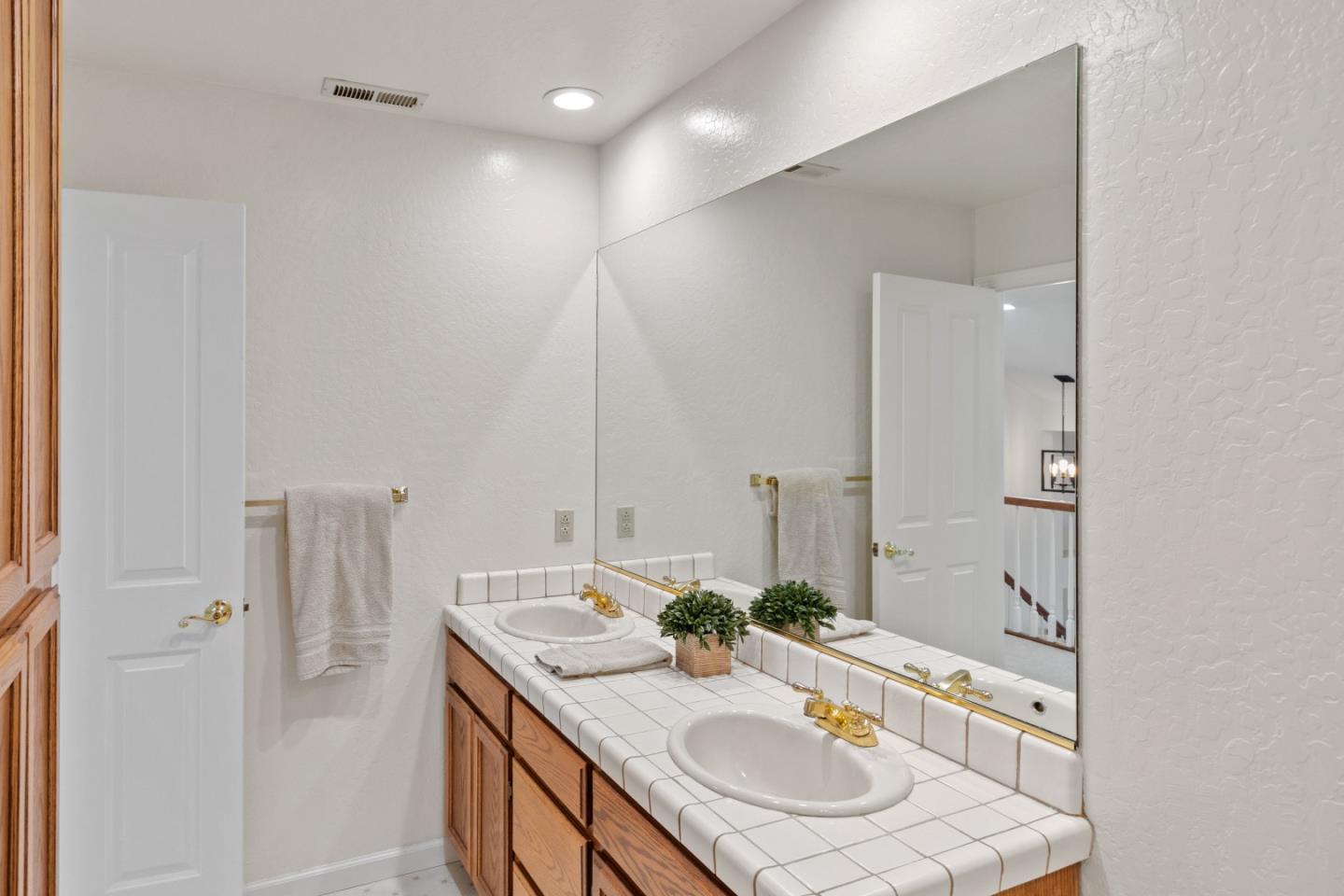 3017 Lopez Road Pebble Beach, CA 93953 - Photo 23 of 30 a bathroom with a granite countertop sink and a mirror