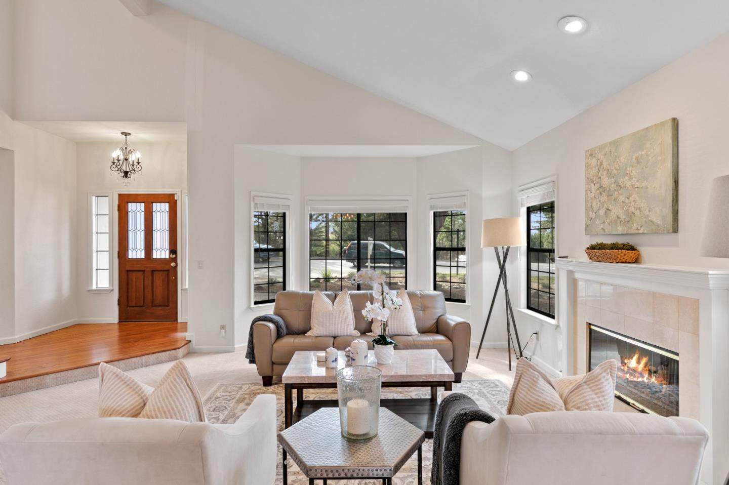 3017 Lopez Road Pebble Beach, CA 93953 - Photo 3 of 30 a living room with furniture a fireplace and a floor to ceiling window