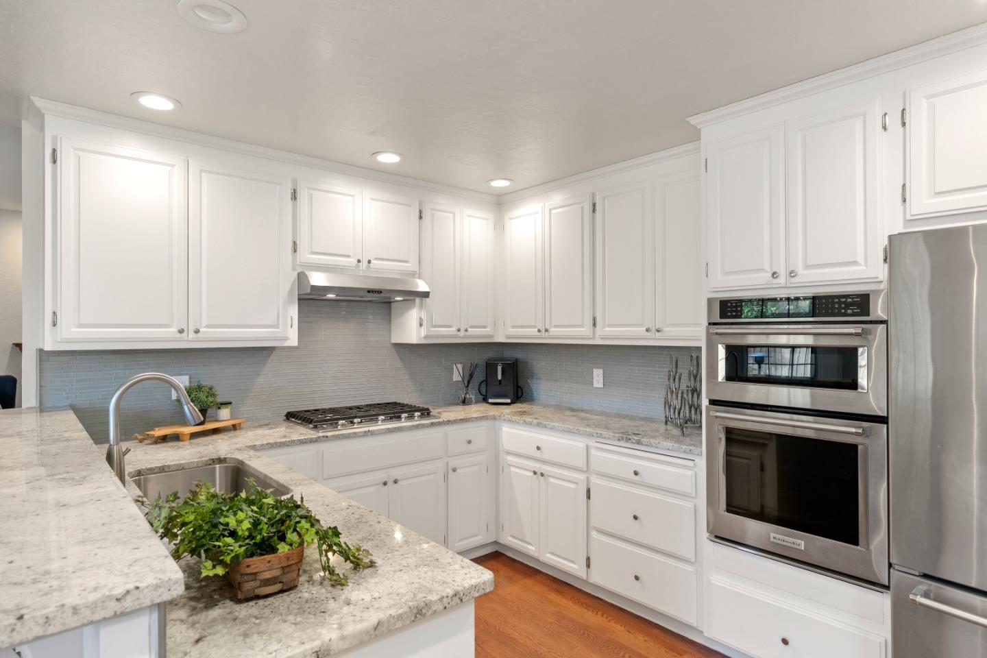 3017 Lopez Road Pebble Beach, CA 93953 - Photo 7 of 30 a kitchen with stainless steel appliances kitchen island granite countertop a stove a sink and a microwave