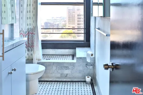 a bathroom with a toilet and a shower