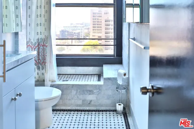a bathroom with a toilet and a shower
