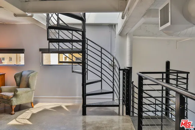 a view of staircase with a rug