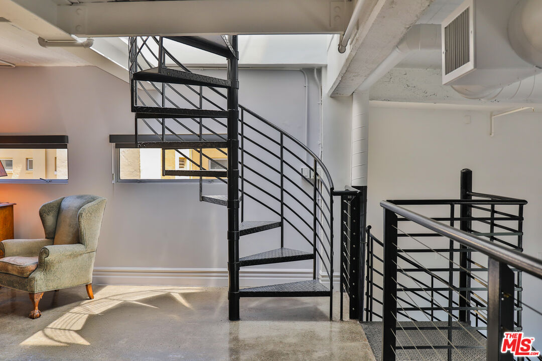 108 West 2nd Street, Unit PH1007 Los Angeles, CA 90012 - Photo 22 of 34 a view of staircase with a rug