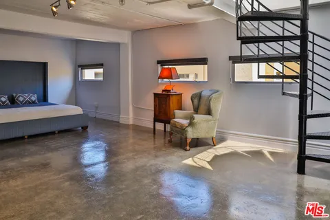 a living room with a bed furniture and a window