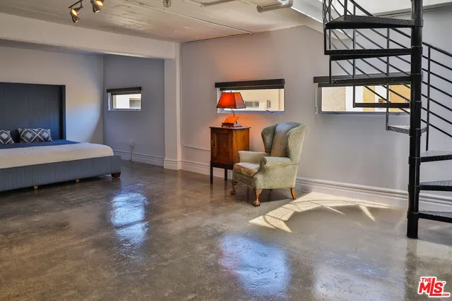 a living room with a bed furniture and a window