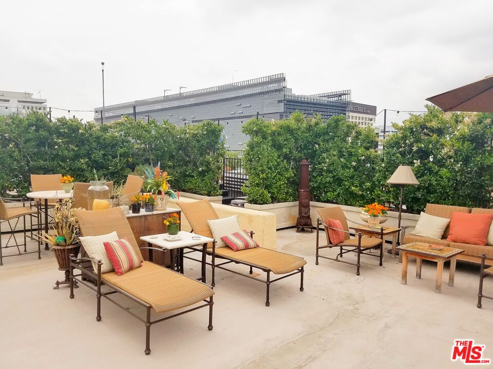 108 West 2nd Street, Unit PH1007 Los Angeles, CA 90012 - Photo 28 of 34 a group of chairs sitting in patio with a table and chairs