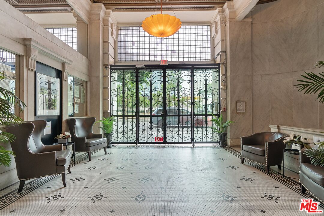 108 West 2nd Street, Unit PH1007 Los Angeles, CA 90012 - Photo 5 of 34 a living room with furniture and a floor to ceiling window