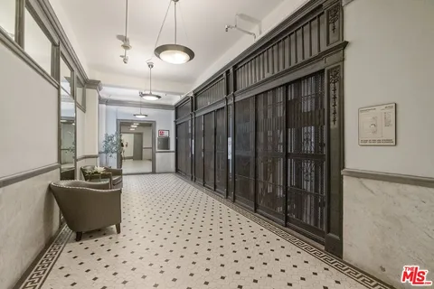 a view of a hallway to a livingroom with furniture