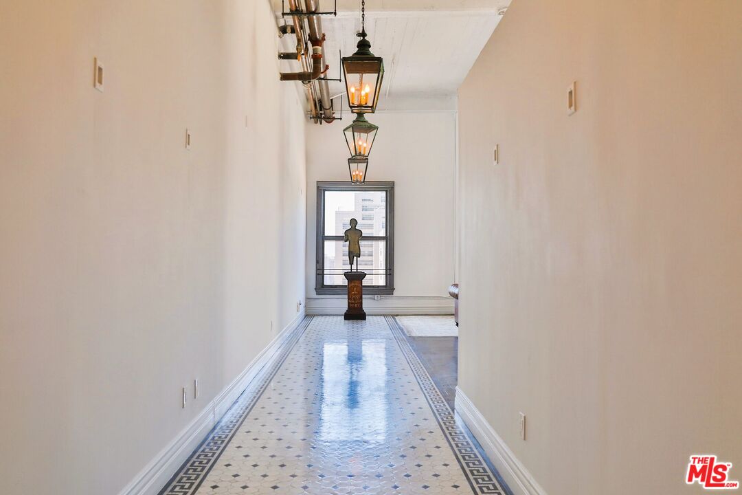 108 West 2nd Street, Unit PH1007 Los Angeles, CA 90012 - Photo 7 of 34 a view of a hallway with wooden floor and staircase