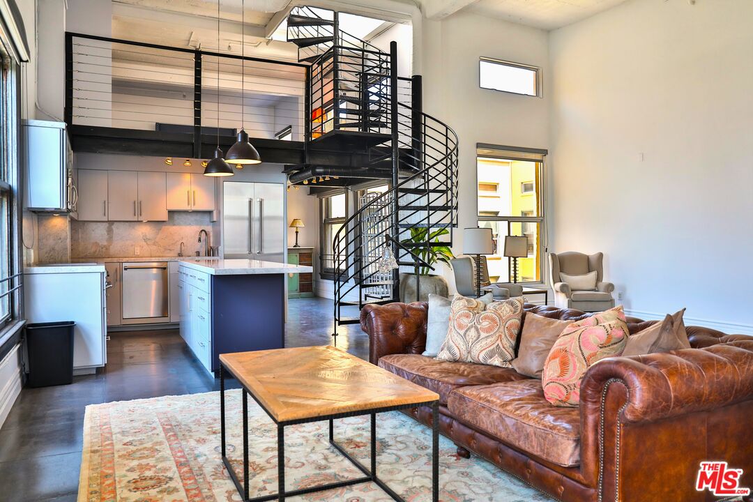 108 West 2nd Street, Unit PH1007 Los Angeles, CA 90012 - Photo 9 of 34 a living room with a couch and a table