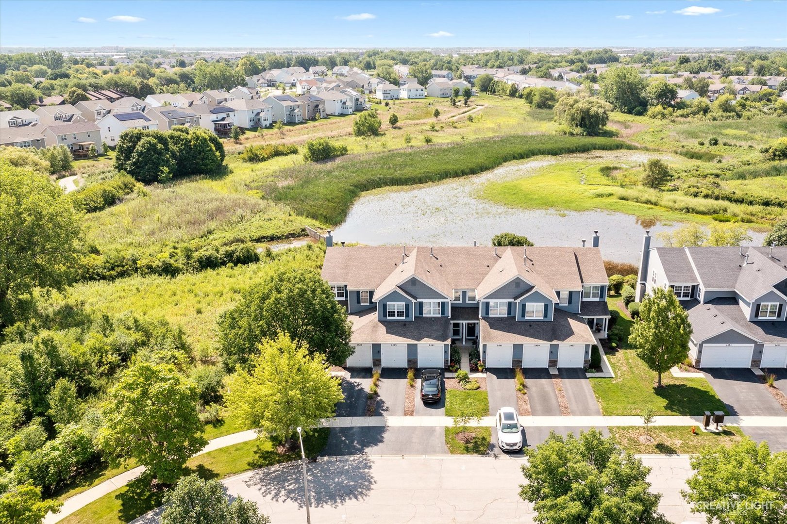 2467 Golf Ridge Circle, Unit 2467 Naperville, IL 60563 - Photo 1 of 25 an aerial view of residential houses with outdoor space