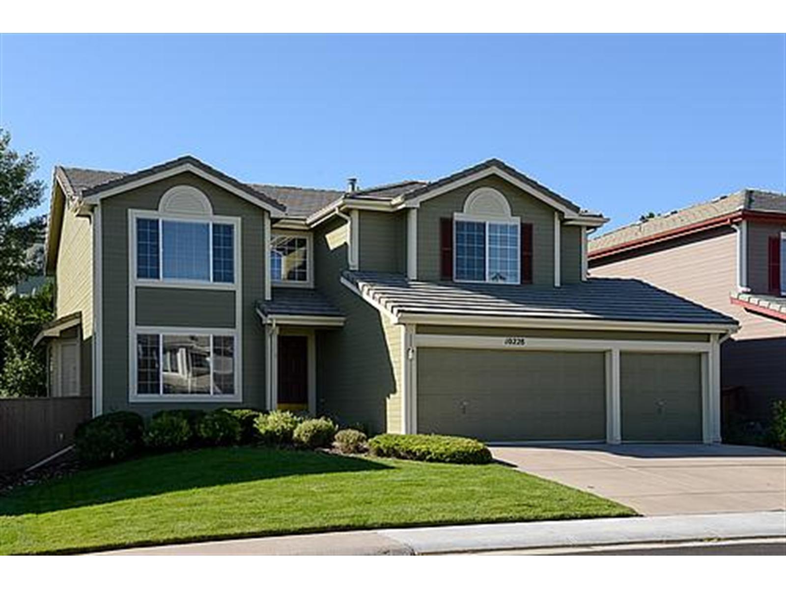 10228 Andee Way Highlands Ranch, CO 80130 - Photo 1 of 1 a front view of a house with a yard and garage