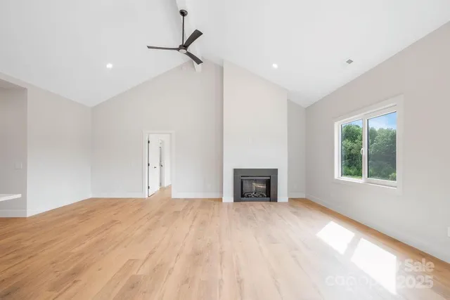 a big room with windows and a fireplace