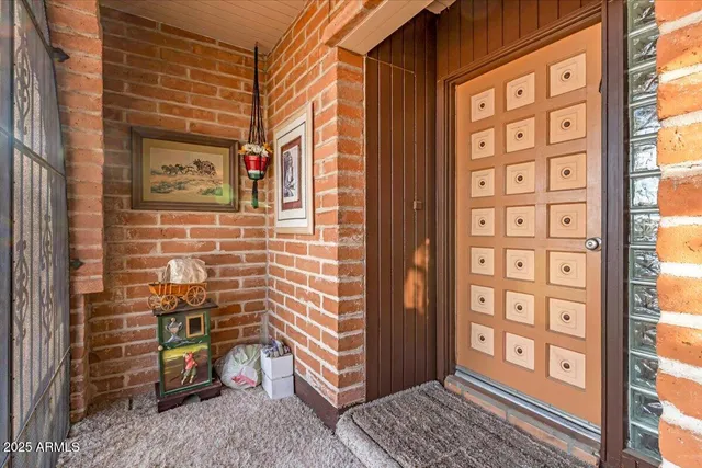 a view of a dining room with furniture and a chandelier