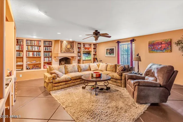 a dining hall with stainless steel appliances granite countertop a stove top oven a dining table and chairs with white cabinets