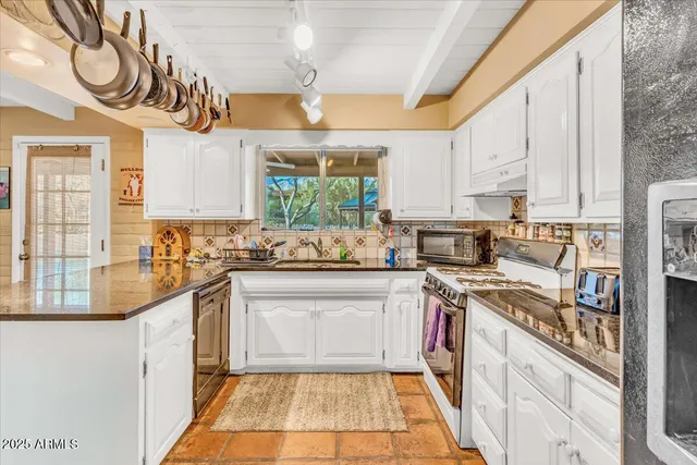 a bedroom with two beds and a chandelier