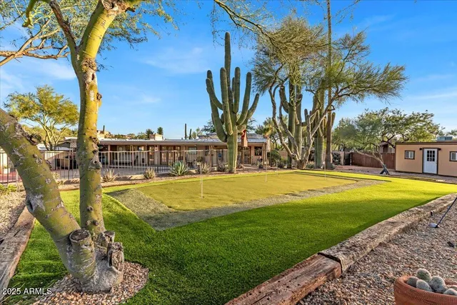 a swimming pool with outdoor seating and yard