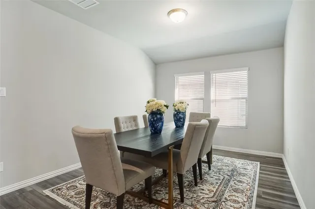 a view of a dining room with furniture and window