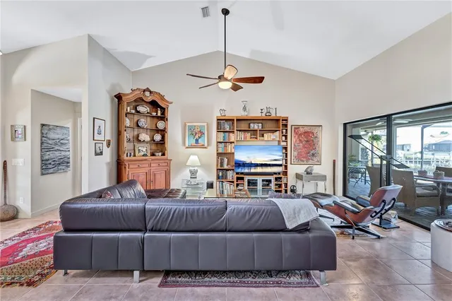 a dining room with furniture a rug and a floor to ceiling window