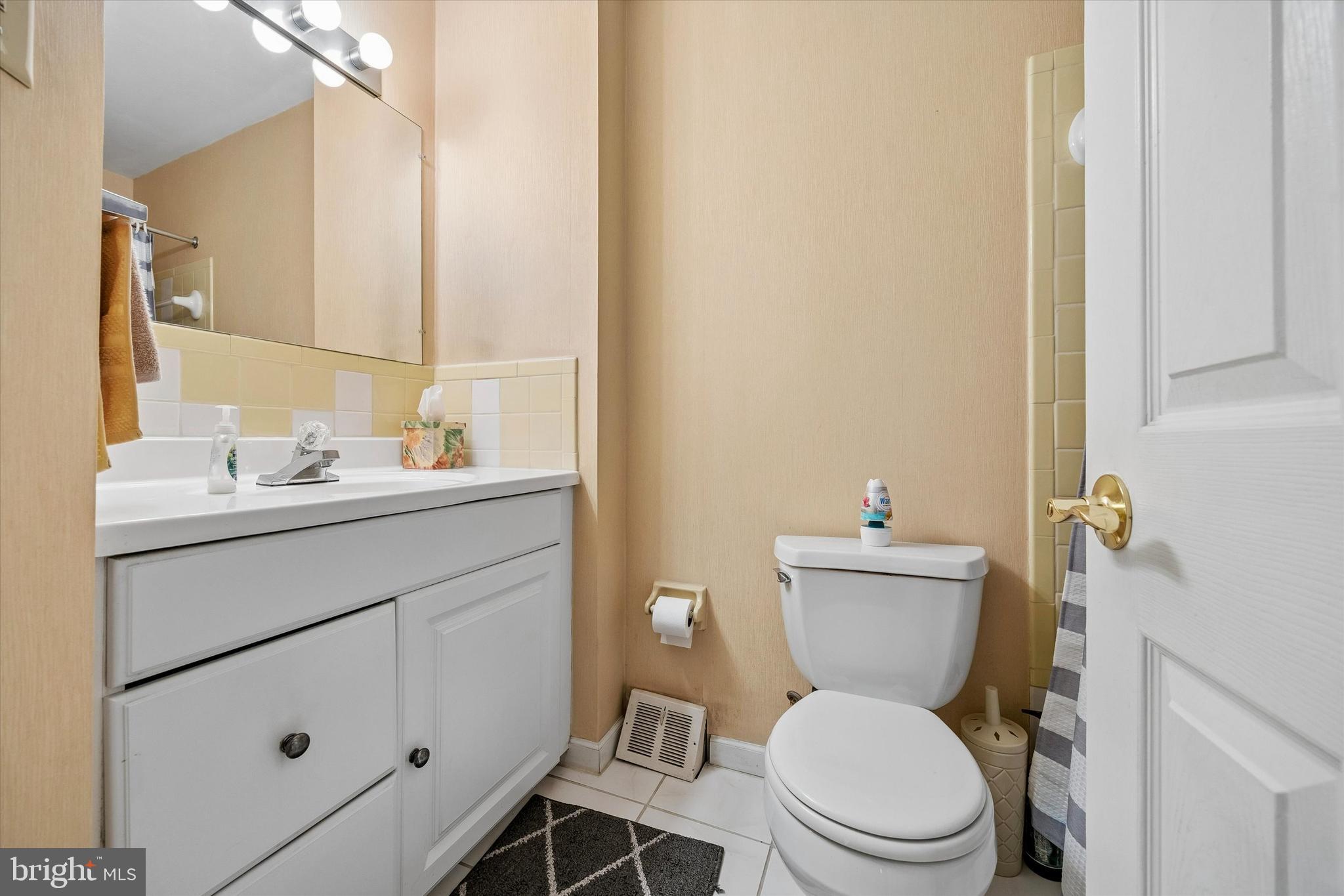 400 Woodhaven Road Philadelphia, PA 19116 - Photo 13 of 25 a bathroom with a toilet sink vanity and mirror