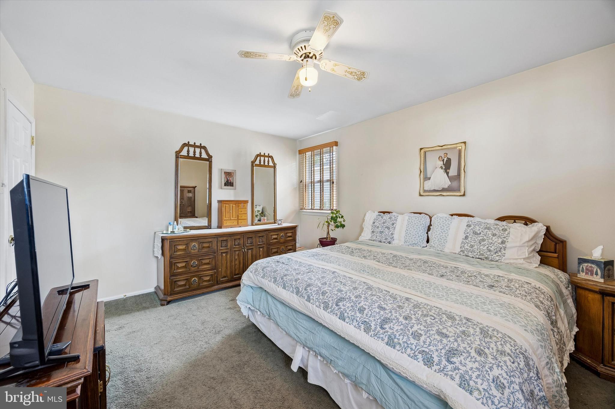 400 Woodhaven Road Philadelphia, PA 19116 - Photo 17 of 25 a bedroom with a large bed a flat tv screen and two mirrors