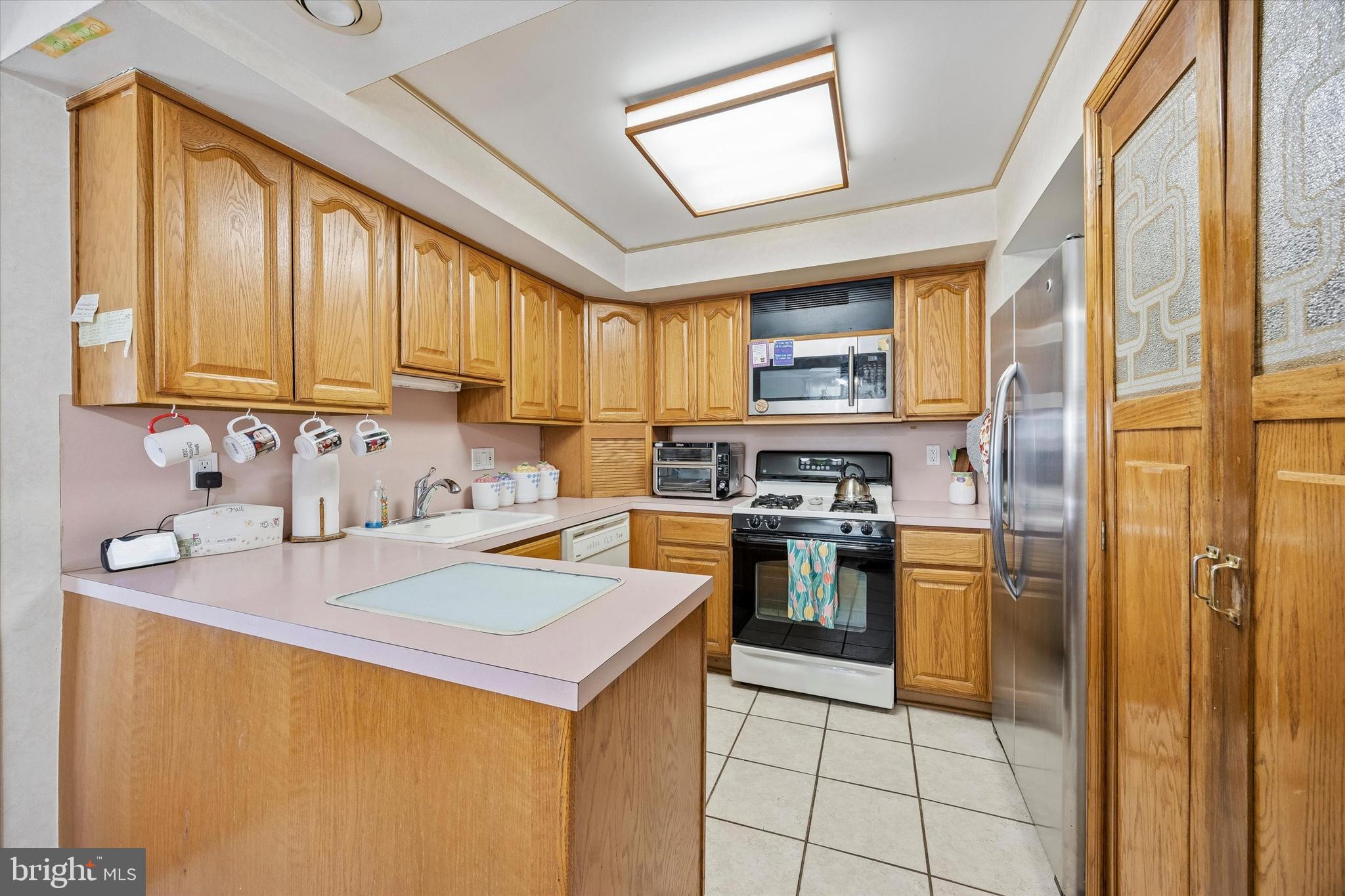 400 Woodhaven Road Philadelphia, PA 19116 - Photo 7 of 25 a kitchen with a sink a stove top oven and cabinetry