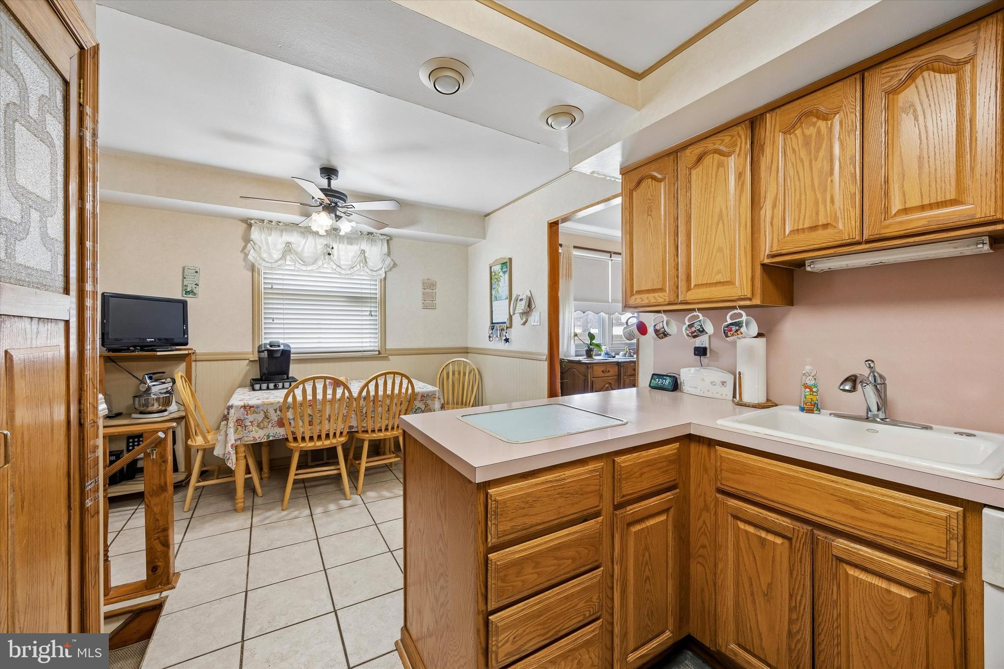 400 Woodhaven Road Philadelphia, PA 19116 - Photo 8 of 25 a kitchen with a sink a stove and chairs