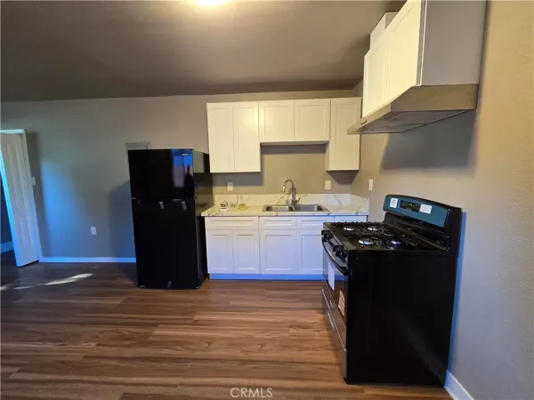 a kitchen with a refrigerator and a stove