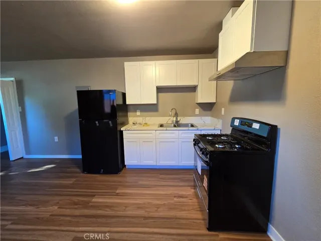 a kitchen with a refrigerator and a stove