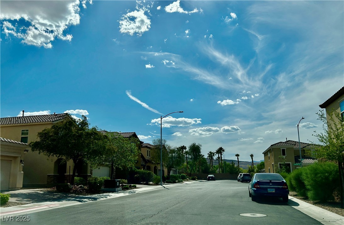8977 Melridge Road Las Vegas, NV 89148 - Photo 33 of 35 View of road with street lighting, a residential view, and curbs