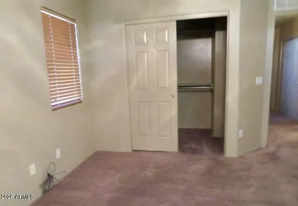 a view of an empty room with a closet