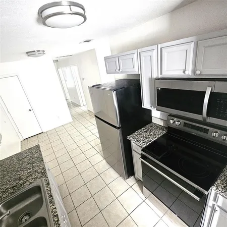 a kitchen with a stove and a microwave