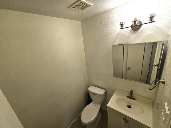 a bathroom with a sink a toilet and mirror