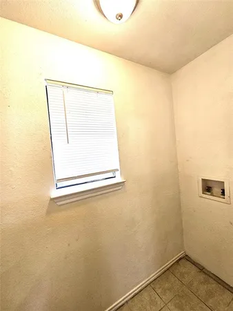 a bathroom with a window and a shower