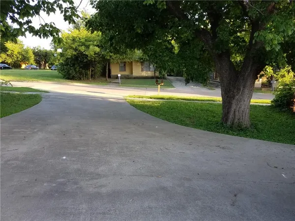 a view of outdoor space with green field and trees