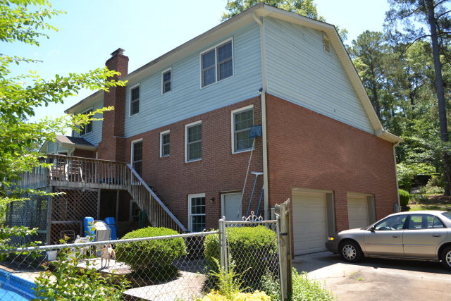230 Castlegate Road Macon, GA 31210 - Photo 2 of 3 a front view of a house with a garden
