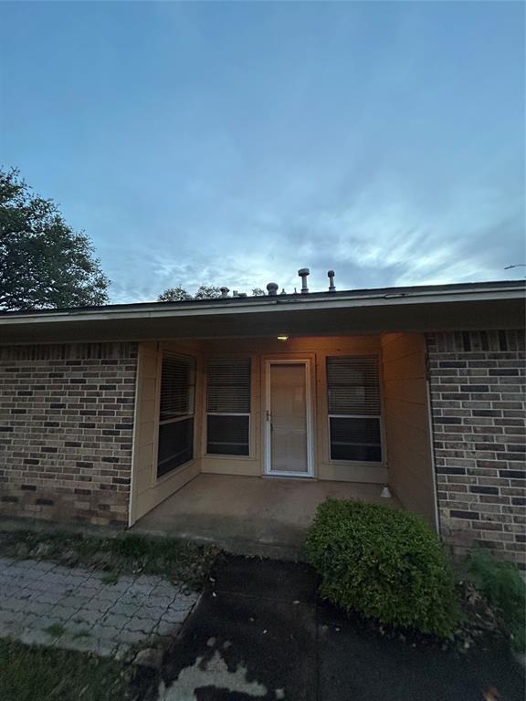 1302 Crescent Street Denton, TX 76201 - Photo 18 of 24 Doorway to property with brick siding