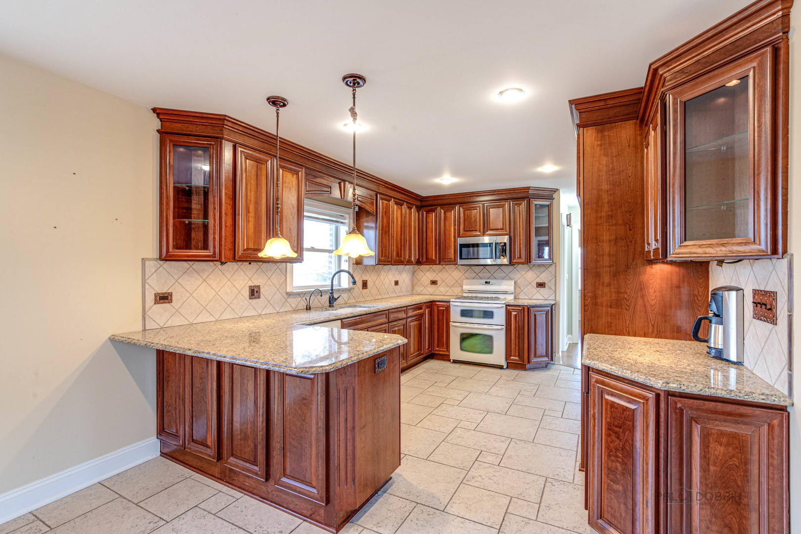 511 Alexander Boulevard Elmhurst, IL 60126 - Photo 12 of 38 a kitchen with stainless steel appliances granite countertop a sink counter space cabinets and a large window
