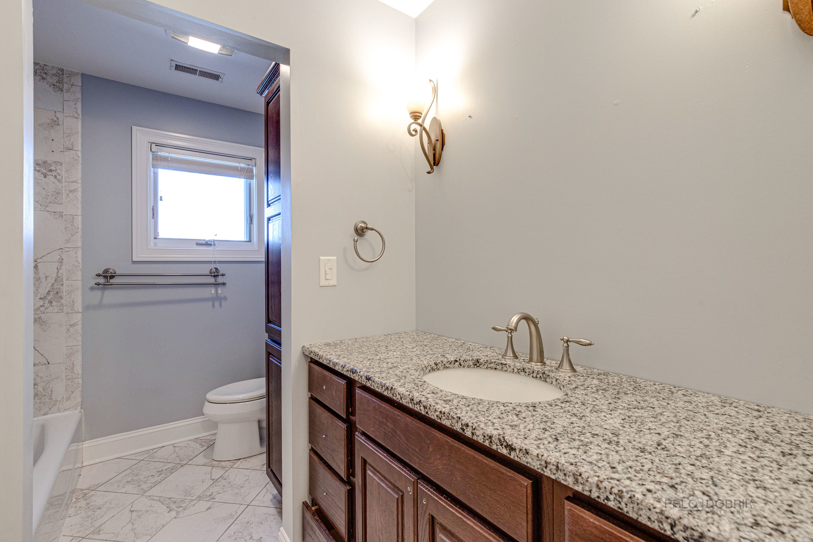 511 Alexander Boulevard Elmhurst, IL 60126 - Photo 22 of 38 a bathroom with a granite countertop sink a toilet and a mirror