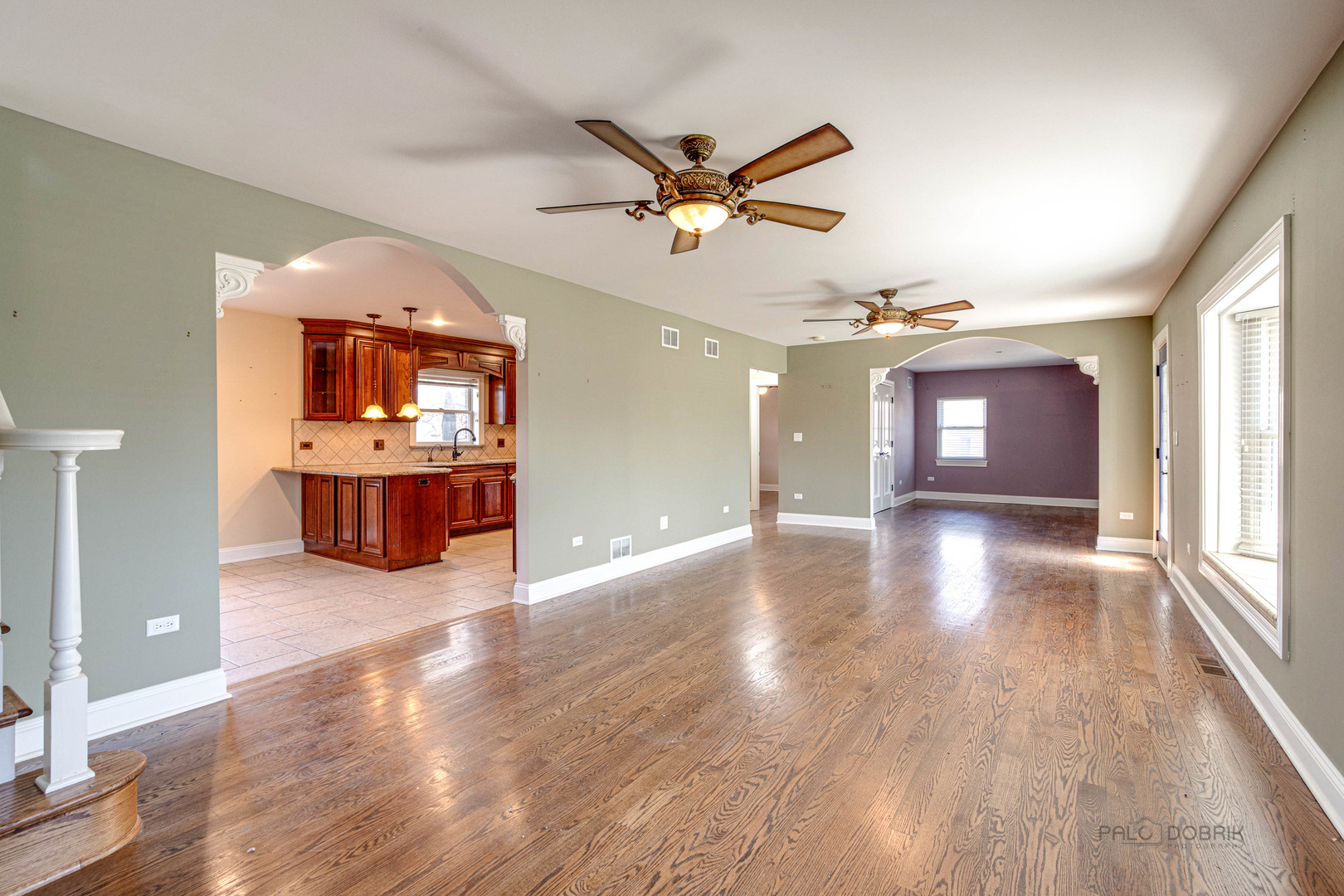 511 Alexander Boulevard Elmhurst, IL 60126 - Photo 8 of 38 wooden floor in an empty room with a window and a kitchen
